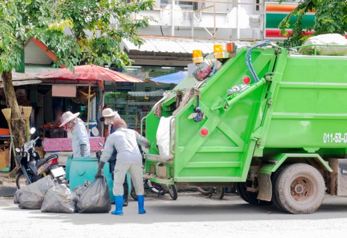 Technician assessing load size for free commercial waste quote